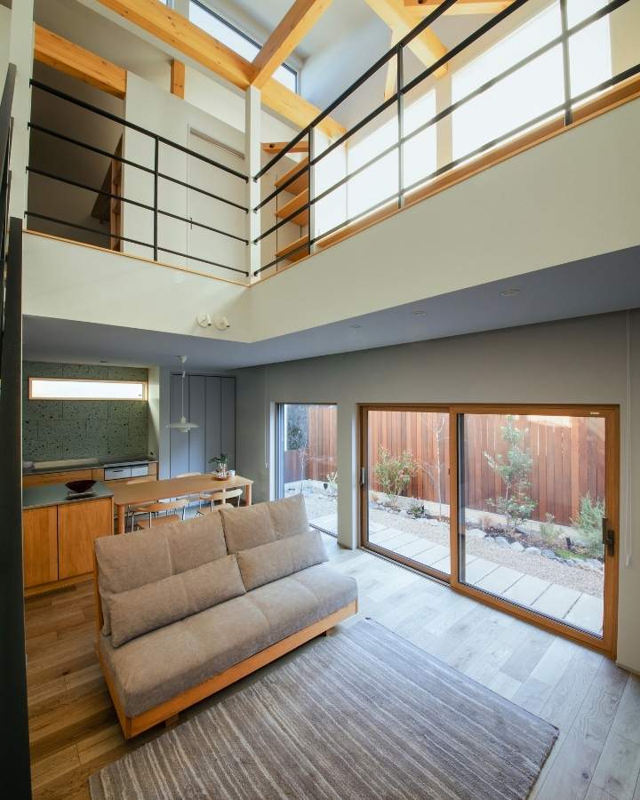 吹き抜けから光が降り注ぐ開放的なリビングと、外の視線を遮るウッドフェンス。岡崎市の注文住宅施工事例。